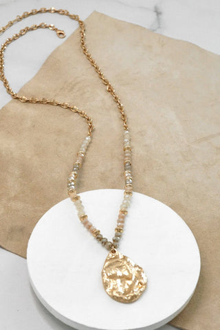 Long Beaded Necklace with Golden Teardrop Pendant in Nude